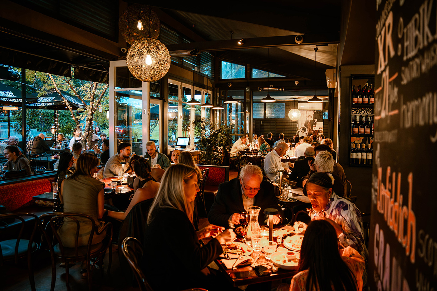 Busy dining room at Goat House with guests enjoying an evening together