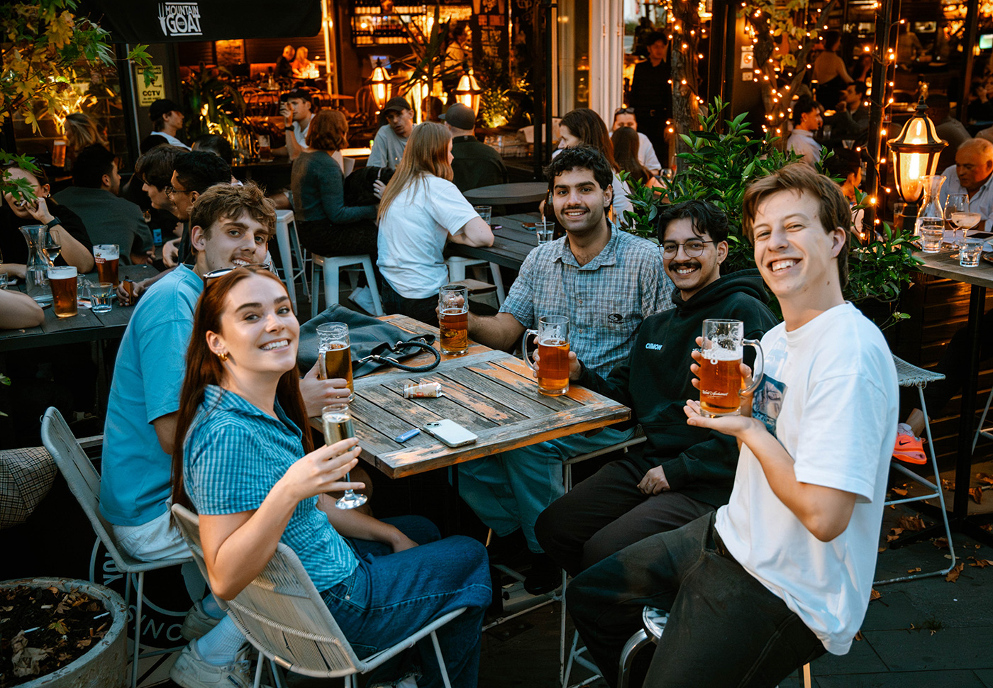Friends enjoying outdoor dining together at Goat House