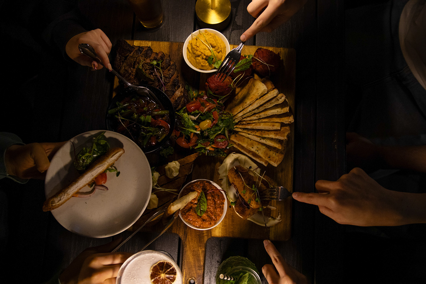 Guests sharing food around a table at Goat House